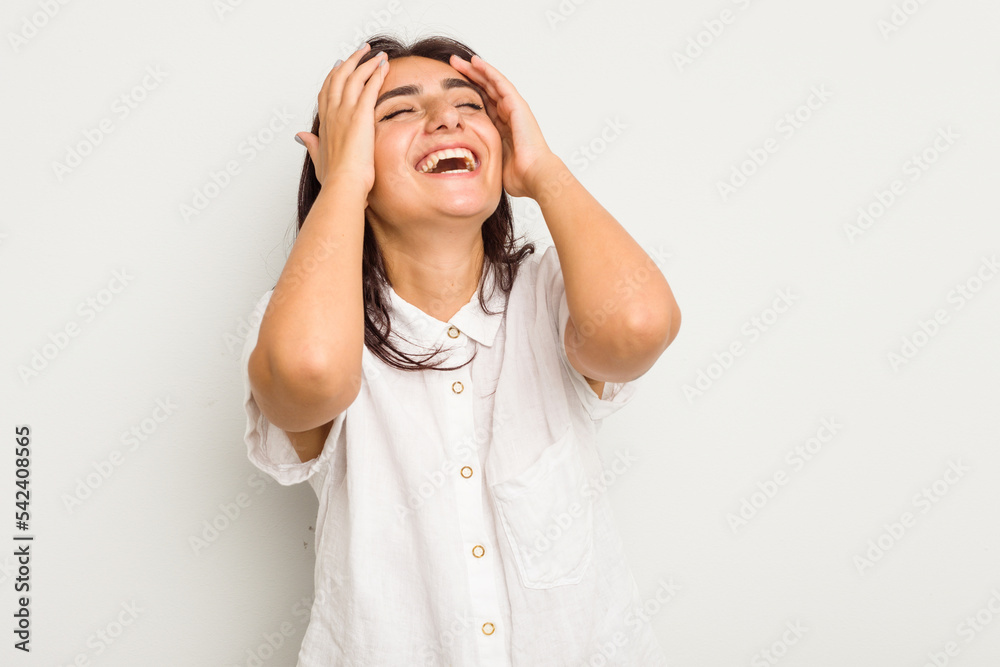 Young Indian woman isolated on white background laughs joyfully keeping hands on head. Happiness concept. Young Indian woman isolated on white background laughs joyfully keeping hands on head. Happiness concept.