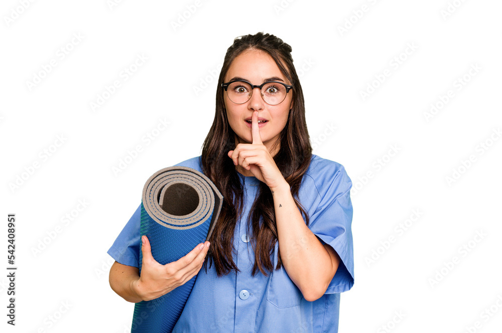 Young caucasian physiotherapist woman holding a mat isolated isolated on green chroma background keeping a secret or asking for silence. Young caucasian physiotherapist woman holding a mat isolated isolated on green chroma background keeping a secret or asking for silence.