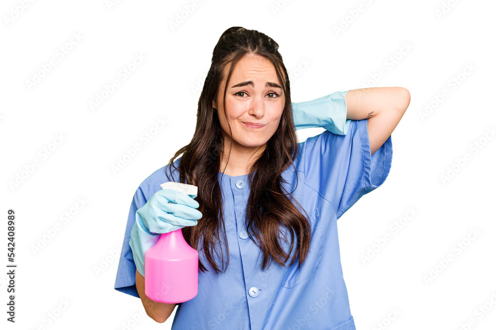Young cleaner caucasian woman isolated on green chroma background touching back of head, thinking and making a choice. Young cleaner caucasian woman isolated on green chroma background touching back of head, thinking and making a choice.