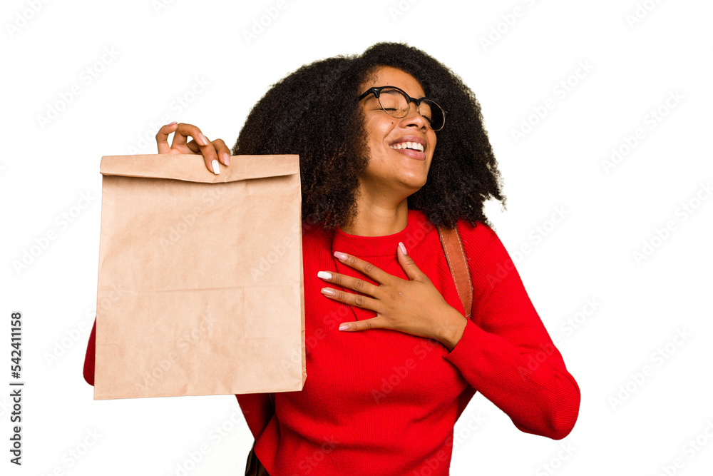 Young African american woman holding take away food isolated laughs out loudly keeping hand on chest.