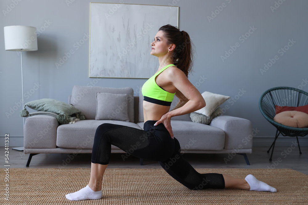 Young woman doing sports exercises at home.Stretching and yoga at home Young woman doing sports exercises at home.Stretching and yoga at home