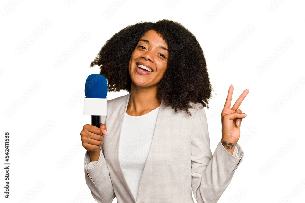 Young TV presenter African American woman with a microphone isolated joyful and carefree showing a peace symbol with fingers. Young TV presenter African American woman with a microphone isolated joyful and carefree showing a peace symbol with fingers.