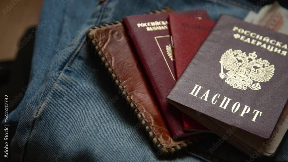 Russian documents and cash money are lying on a stick of things, the man is going to leave Russia. Russian documents and cash money are lying on a stick of things, the man is going to leave Russia.
