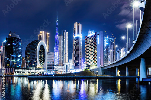 Skyscrapers skyline of Dubai UAE downtown with Burj Khalifa at night. photo