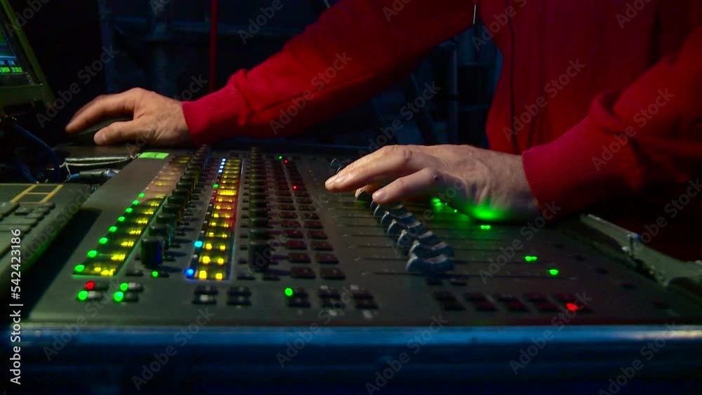 sound engineer's hands on the sound console during operation sound engineer's hands on the sound console during operation