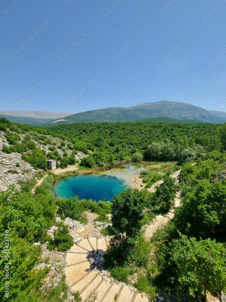 Emerald lake in Zelenogorye, Crimea, surrounded by the hills under the clear sky