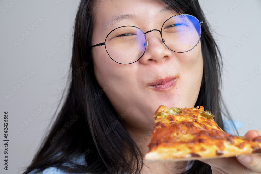 Happy glasses Asian young woman eat Pizza on white background. Happy glasses Asian young woman eat Pizza on white background.