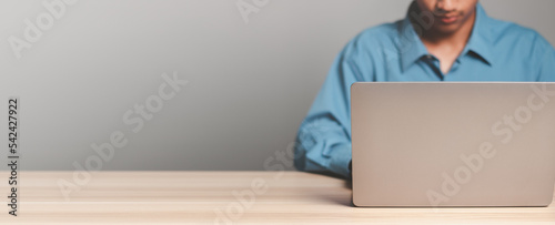 Businessman using laptop computer writing email or message, chatting, shopping. Working online on computer. Copy space.