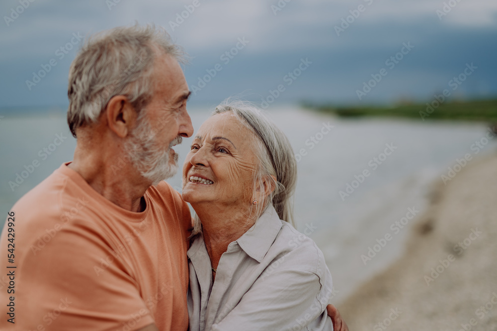Senior couple relaxing and having romantic moment near the autumn sea. Senior couple relaxing and having romantic moment near the autumn sea.