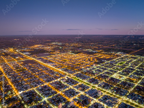 City full of lights aerial view at dusk. Orthogonal urban layout, also known as reticular or squared (Grid plan)