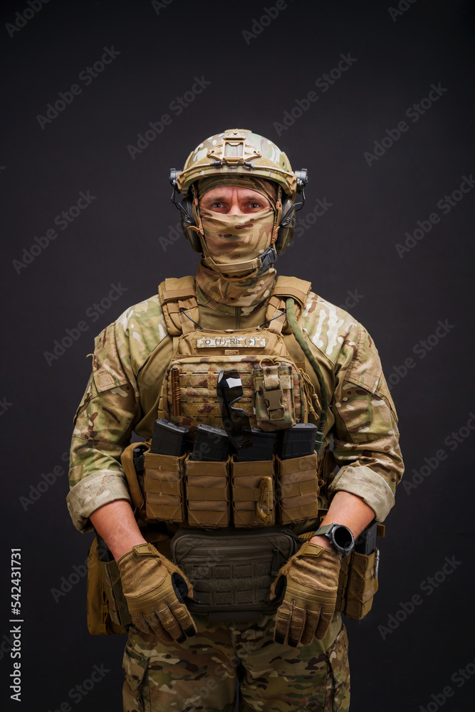 Elit member of Armed Forces of Ukraine man on black background. Soldier man dressed in military ammunition posing on black background. Army soldier with in camouflage clothing Elit member of Armed Forces of Ukraine man on black background. Soldier man dressed in military ammunition posing on black background. Army soldier with in camouflage clothing