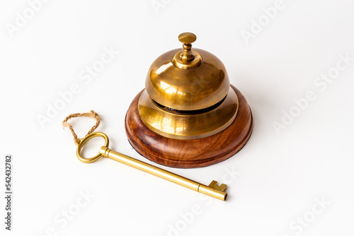 Vintage golden hotel service bell with key