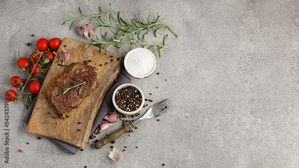 Grilled sliced beef steak on wooden cutting board. Panoramic top view. Free space for text. Grilled sliced beef steak on wooden cutting board. Panoramic top view. Free space for text.