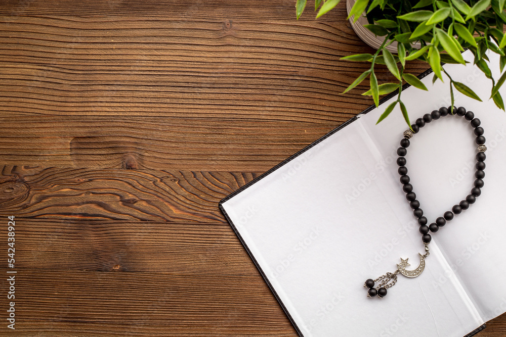 Black Muslim rosary and Koran book. Islamic background Black Muslim rosary and Koran book. Islamic background
