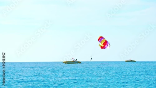magnificent view of colorful parasail wing pulled by a boat in the bright blue sea, Alanya, Turkey. High quality 4k footage