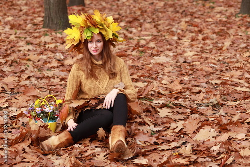 Young woman with flowers in autumn park