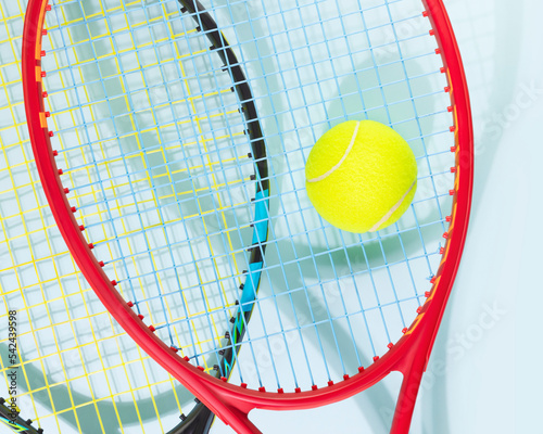 Tennis competition card. Sport composition with yellow tennis ball and tennis rackets on a blue background.Tennis game. Sport and healthy lifestyle © KRISTINA KUPTSEVICH