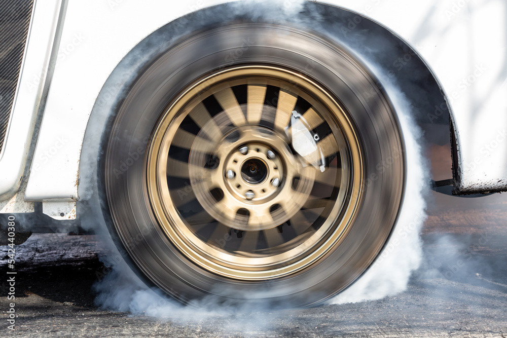 Car wheel spinning wheel and smoking, Race car doing lot of smoke on race track, Car wheel drifting and smoking on track. Car wheel spinning wheel and smoking, Race car doing lot of smoke on race track, Car wheel drifting and smoking on track.