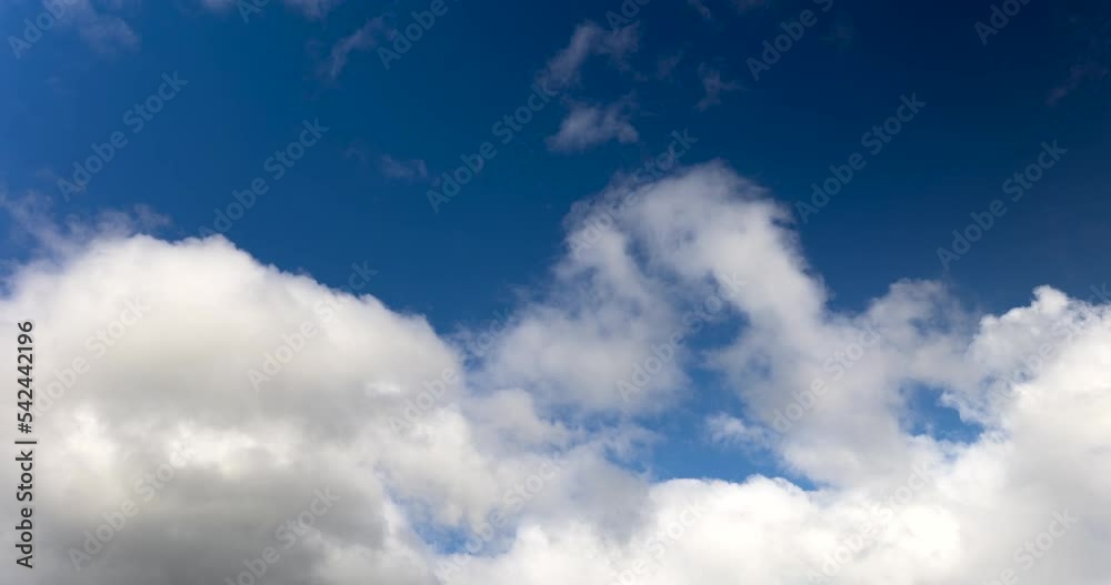 Fluffy White Clouds Moving Against Deep Blue Sky. time lapse Fluffy White Clouds Moving Against Deep Blue Sky. time lapse