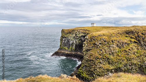 Coastline cliffs with basalt columns at Arnarstapi, scenic and thriving tourism destination in Iceland.