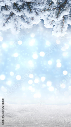 Screensaver wallpaper for smartphone with winter background. Christmas, New Year's composition with fir snow-covered branches and blurry garland lights. Banner 2023.