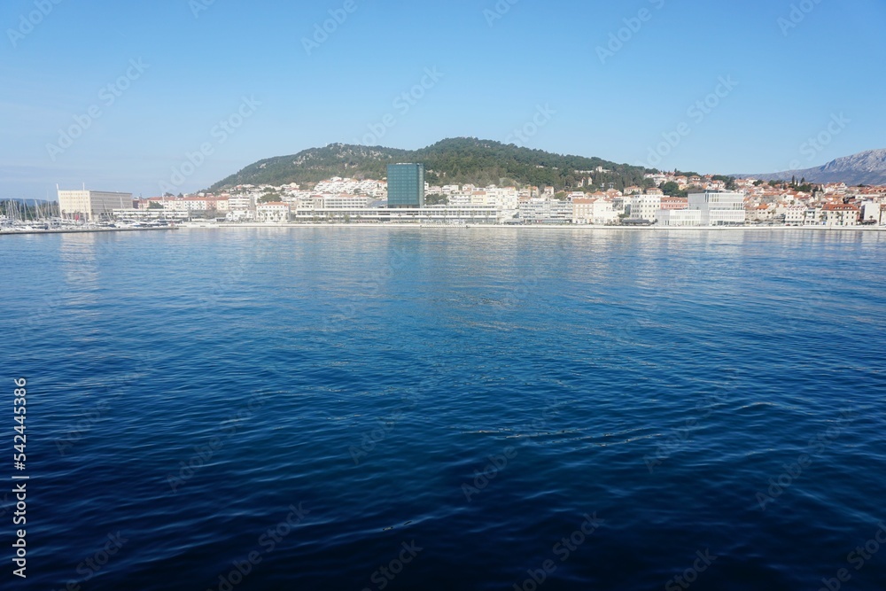 Scenic view of the blue sea with dense coastline buildings under the clear blue sky