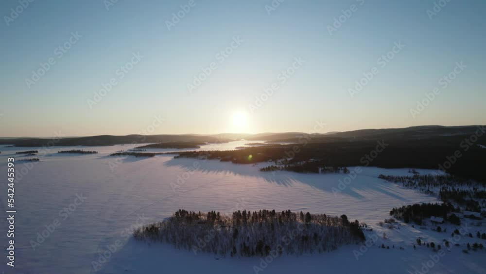 Beautiful sunrise over frozen Inari Lake in Lapland, Finland Beautiful sunrise over frozen Inari Lake in Lapland, Finland