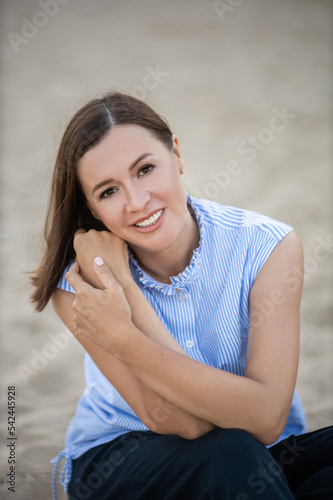 Smiling Woman on a Beach.
Outdoor portrait of a young beautiful romantic woman.
