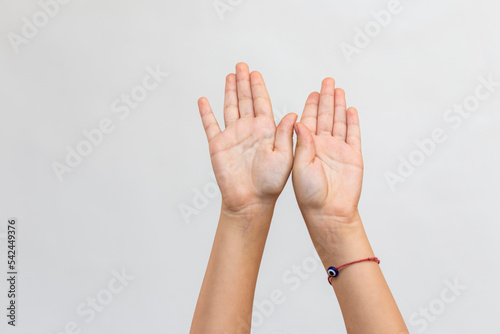 close up view of raised hand of a kid against white background