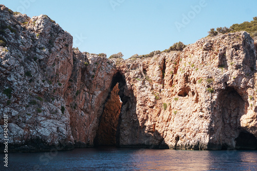 Suluada Island coastal view on the Mediterranean Sea. Sea caves in the mediterranean