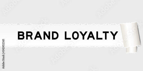 Ripped gray paper background that have word brand loyalty under torn part
