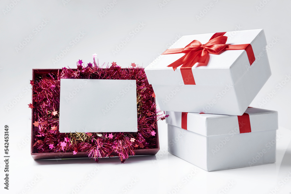 Fototapeta premium Opening gift box with Christmas ornament and empty paper