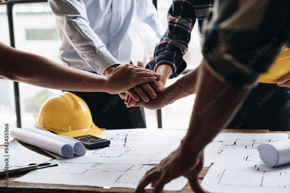 Businessman handshake with engineering in construction renovate building site. Engineer/architect inspection workplace for project.Teamwork construction engineer,business and architecture concept. - obrazy, fototapety, plakaty 