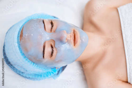 beautiful woman with blue alginate mask on face