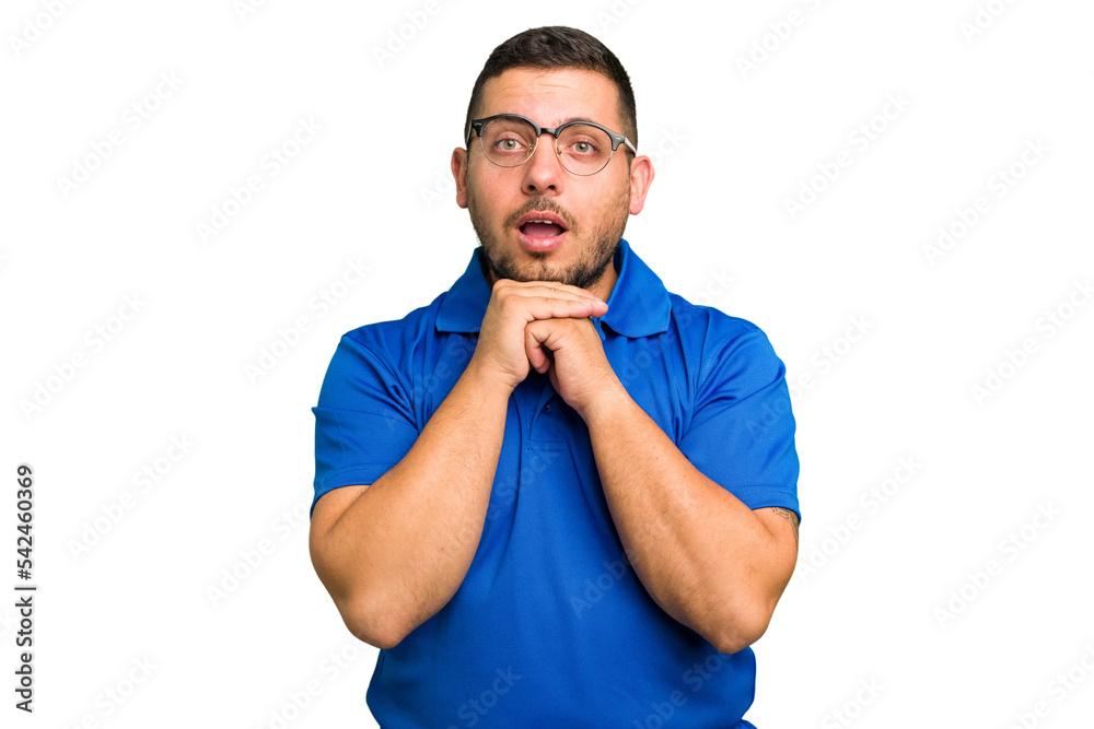 Young caucasian man isolated praying for luck, amazed and opening mouth looking to front. Young caucasian man isolated praying for luck, amazed and opening mouth looking to front.