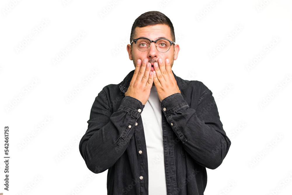 Young caucasian man isolated shocked, covering mouth with hands, anxious to discover something new. Young caucasian man isolated shocked, covering mouth with hands, anxious to discover something new.
