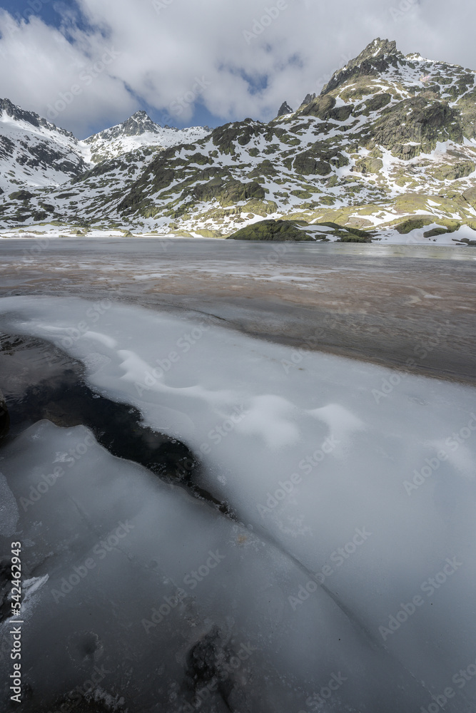 Snowy mountains above lake in winter Snowy mountains above lake in winter