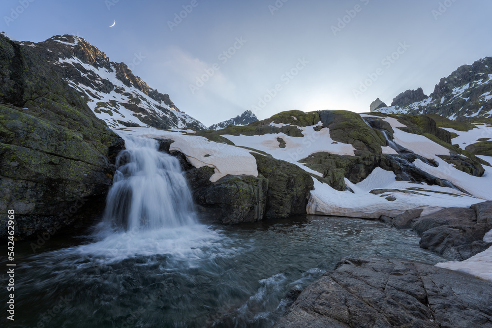 Splashing waterfall from rock in snowy mountains Splashing waterfall from rock in snowy mountains