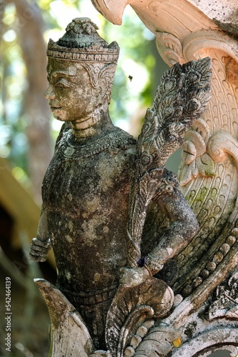 Vertical shot of a weathered buddhist statue photo