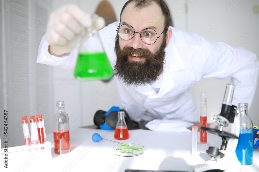 Chemist crazy. A mad scientist conducts experiments in a scientific laboratory. Performs research using a microscope. Chemist crazy. A mad scientist conducts experiments in a scientific laboratory. Performs research using a microscope.