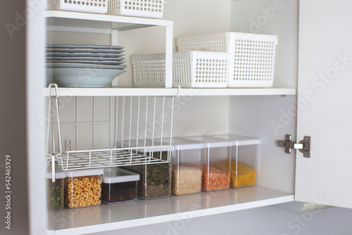 House decor ideas. Storage in the kitchen. Home organization. White shelf and modern interior.