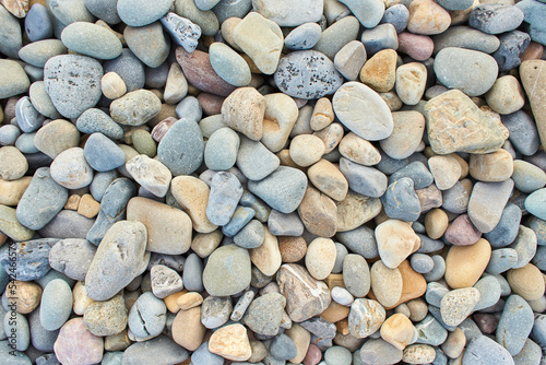 Stone background - pebble stones texture. Cobblestone. Detail view of patterns of beach stones and pebbles.