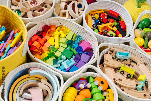 Wallpaper Mural Colorful Toy Storage Baskets in the children's room. Cloth stylish Baskets with wooden toys. Organizing and Storage Ideas in nursery. Clean up toys and reduce the clutter. Top view Torontodigital.ca