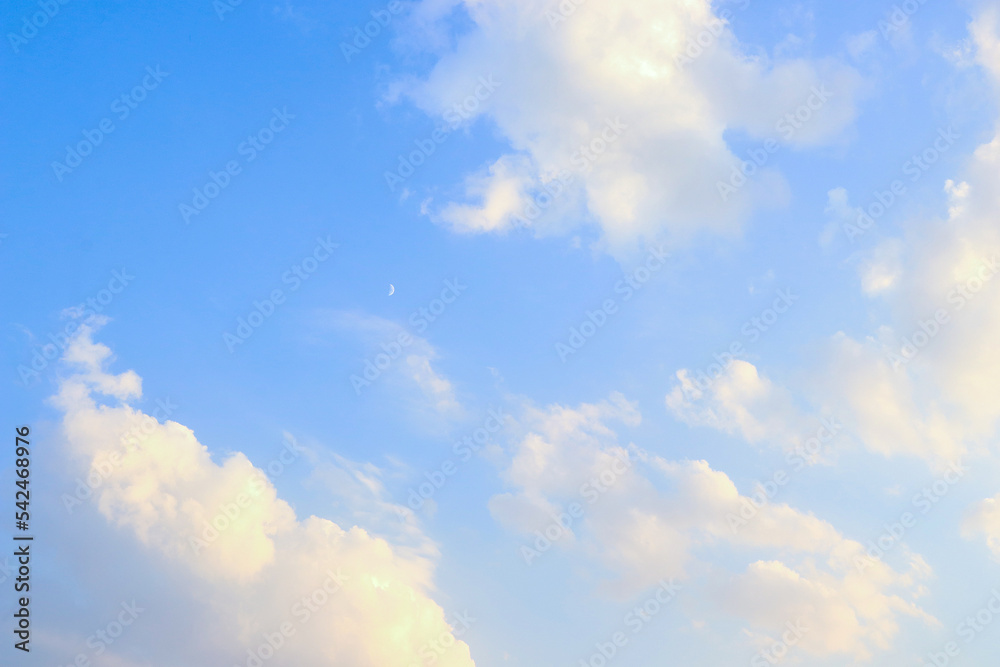 Moon in daylight On the bright sky, clouds and blue sky
