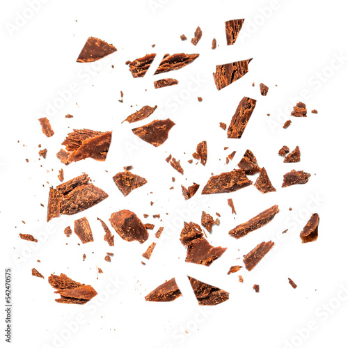 Cracked broken chocolates isolated on white background. Flying Milk Chocolate chips pieces Top view. Flat lay..