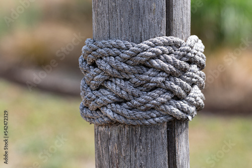 Closeup of ropes tied around a wooden pole © andre