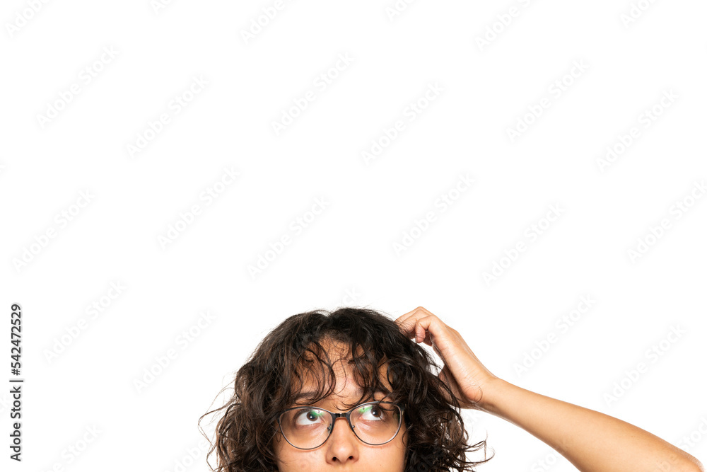 closeup portrait headshot cropped face above lips of cute puzzled woman in glasses looking up isolated on white studio wall background with copy space above head. Human face expressions closeup portrait headshot cropped face above lips of cute puzzled woman in glasses looking up isolated on white studio wall background with copy space above head. Human face expressions