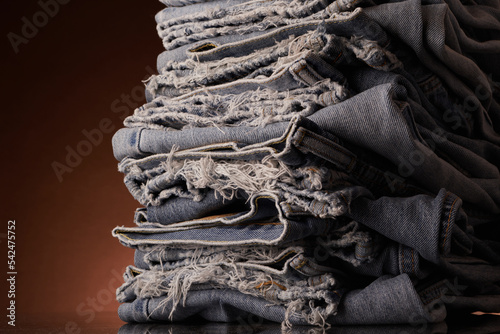 Neatly folded, but tattered laundry / blue jeans