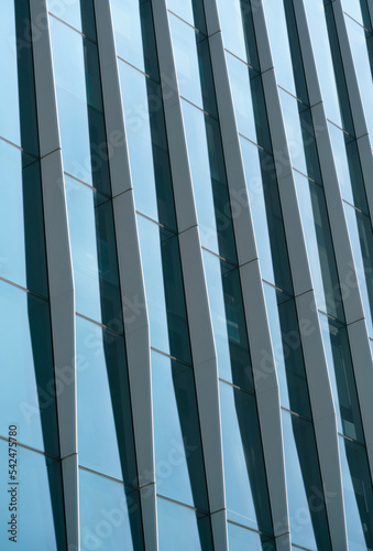 close-up soft light pattern glass wall facade exterior architecture building reflection blue sky clean environment background. modern business office concept,smart city backdrop cover minimal design.