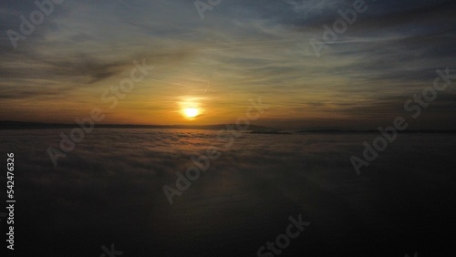Scenic shot of fiery sunset above the clouds in Meersburg  Germany  for background